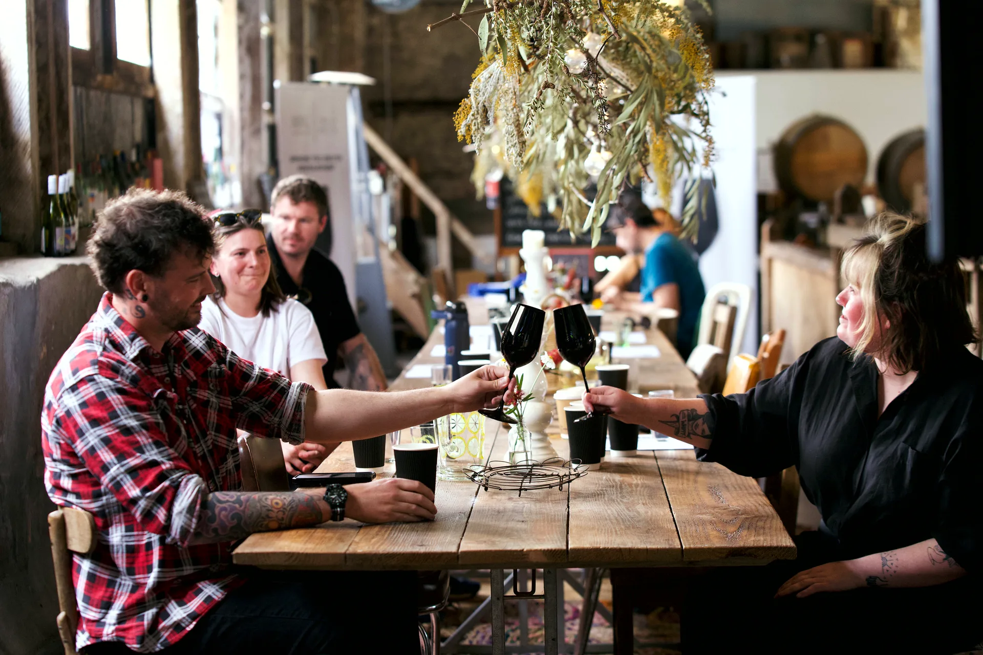 Two players clink black glasses down the long table in Bellwether's shearing shed.